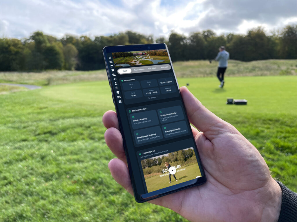 Golfer holding a golf club app on a phone beside the course.