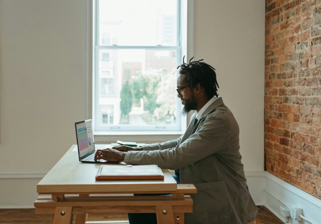 Committee member reviewing records on a laptop